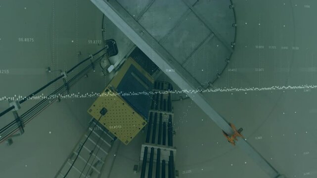 Industrial silo being rendered in overhead view featuring platform ladder boom waveform overlays