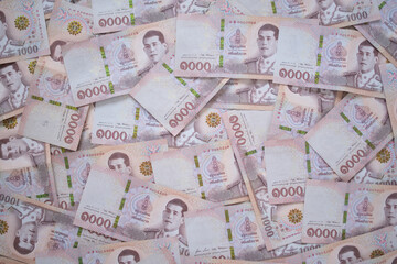 Thai currency , Many THAI bank notes Placed on the table.The  Baht is the currency of Thailand that is used to change, buy, sell, accumulate, and invest in Thailand stock..