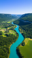 Aerial view of India river a winding turquoise river flowing through a lush green valley with forests and fields.