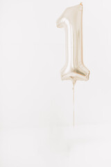 Single metallic number one balloon against white background with copy space
