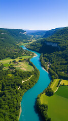 Aerial view of Jhelum river a winding turquoise river flowing through a lush green valley with forests and fields.