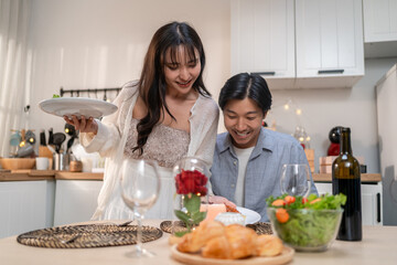 Asian young couple having dinner to celebrate valentine's day together.