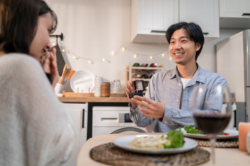 Asian romantic man surprise his girlfriend with a marriage proposal. 