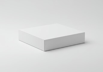 Fototapeta premium A simple studio shot of a small square white box sitting on a white surface with soft shadows around it