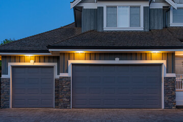 Garage door in luxury house with trees and nice landscape in Spring in Vancouver, Canada, North...
