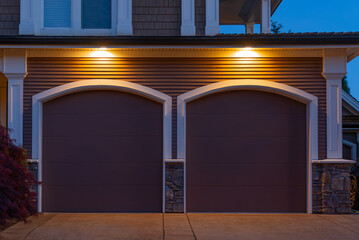 Garage door in luxury house with trees and nice landscape in Spring in Vancouver, Canada, North...