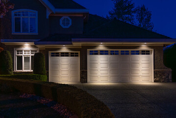 Garage door in luxury house with trees and nice landscape in Spring in Vancouver, Canada, North...