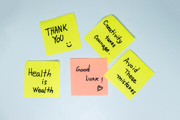 Positive affirmations concept. Phrases of different colors sheets for notes on a green background....
