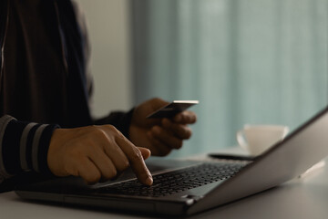 Customer is hand paying for service subscription with credit card on laptop at home office. Subscription business model concept. Follow the subscription membership monthly plan package on social media