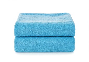 Two neatly folded light blue towels stacked on top of each other on a white background surface