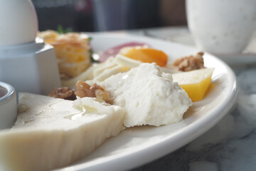 Delicious breakfast spread featuring fresh cheeses and fruits