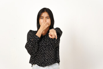 Smelling something stinky and disgusting Of Beautiful Asian Woman Wearing black Isolated On White...
