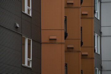Brown highlights  in row made by walls of tall apartment buildings