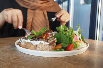 Healthy Salad and Gourmet Toast Served on a Wooden Dining Table