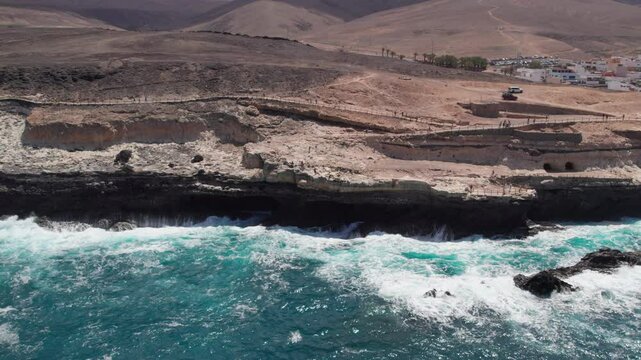 An aerial view of the path leading to the Ajui Caves on the island of Fuerteventura, where hikers can be seen following it. Canary Islands, Spain.