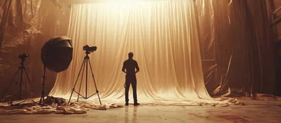 Studio setup with large backdrop, photographer adjusting light
