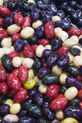 Colorful olives displayed in a vibrant market setting