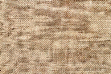 Coarse natural burlap fabric. The texture of natural burlap.