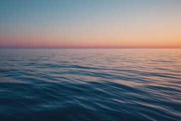 Obraz premium gentle waves ripple across ocean at sunrise