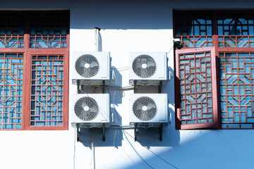 Structure white big air conditioner compressor source heat pumps attached set on concrete wall....