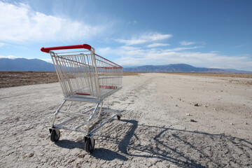 Empty shopping cart in desert
