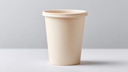 minimalistic image of single recycled paper cup surrounded by ample copy space against clean white background