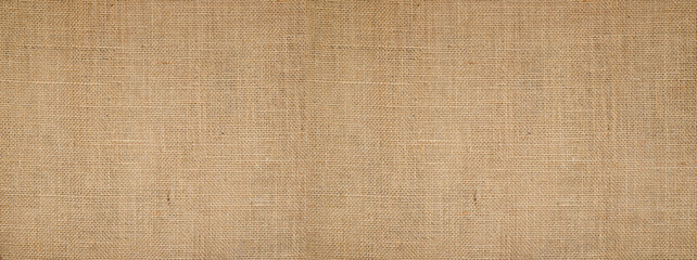 Cotton woven fabric background with flecks of varying colors of beige and brown. with copy space....