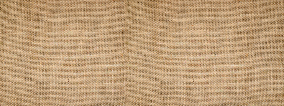 Cotton woven fabric background with flecks of varying colors of beige and brown. with copy space. office desk concept, Hessian sackcloth burlap woven texture background High Resolution ,panoramic	