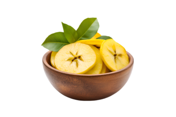 Sliced yellow apples in wooden bowl with green leaves