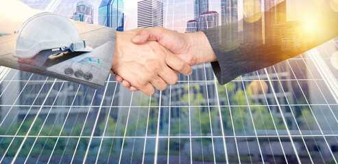 Businessmen shaking hands against of solar panels symbolizing commitment to ESG principles.