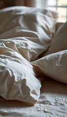 unmade bed with white sheets and pillows