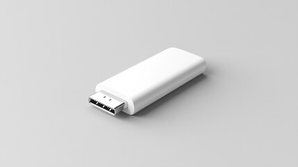 A white USB flash drive with rounded edges, lying flat on a light grey background 