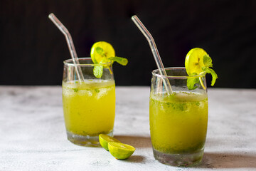 A refreshing cocktail made with mint leaves, lime, sugar, soda water, and rum, offering a cool, tangy, and invigorating flavor.
