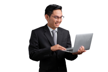 Smiling Asian businessman in suit holding and using laptop, isolated on transparent background