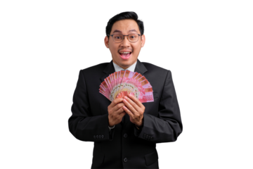 Happy Asian businessman in suit holding fan of money and smiling, celebrating financial success, isolated on transparent background