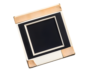 Vintage Photo Slide: A close-up shot of an antique photo slide, featuring a worn, off-white mount with copper-toned corner reinforcements, a dark central space ready for image insertion.