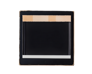 Vintage Camera Slide: An aged camera slide featuring a central black frame, indicative of analog photography's rich past. Emphasizing the aesthetic of classic media.