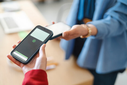 A customer is paying a vendor by tapping their phones together. This is a quick and easy way to transfer money.
