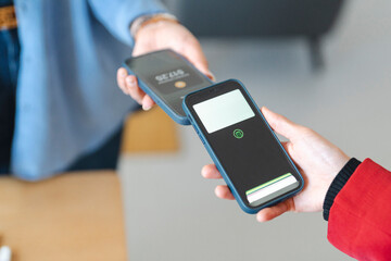 A customer is paying a vendor using a mobile payment app. They are using this method for a quick and contactless transaction.