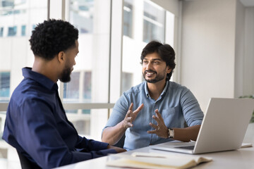 The businessmen engaged in formal discussion met in office boardroom. Indian boss make speech, talk about upcoming project details, express opinion, share strategy and solution. Teamwork, negotiation