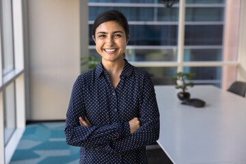 Office portrait of professional woman, female executive manager or company CEO posing with...
