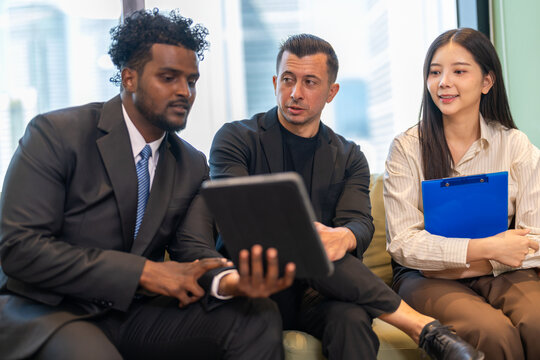 Businesswoman insurance agent presenting health or auto insurance policy details to businessmen, risk assessment and coverage consultation, financial planning, protection, security and investment