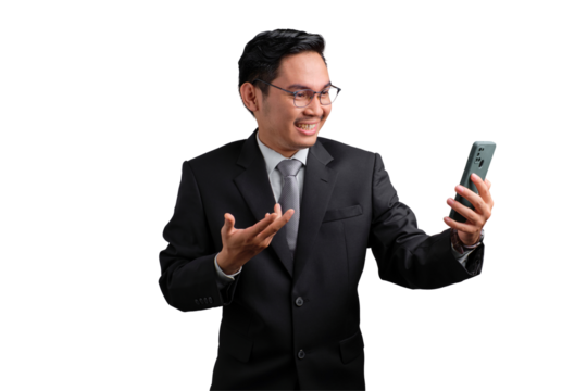Smiling Asian businessman in suit holding smartphone and talking, isolated on transparent background - Powered by Adobe