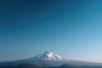 Fototapeta premium clear blue sky with single focused mountain peak in distance represents boundless ambition and determination