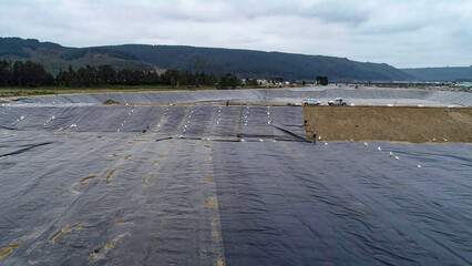 Geomembrane deployment and installation process with machinery in the construction of water pools