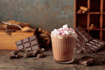 Hot chocolate drink with marshmallows on a brown background.