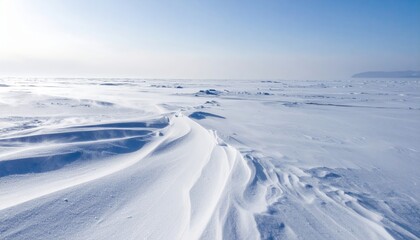 Obraz premium Winter wonderland Breathtaking view of snowdrifts and a frozen landscape under a clear blue sky