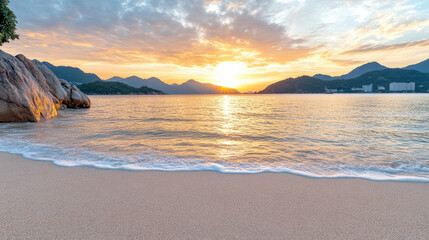 Fototapeta premium Golden sunset over tranquil beach with gentle waves lapping at shore
