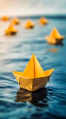 Closeup of a Vibrant Yellow Paper Boat Floating on Rippling Blue Water Surface