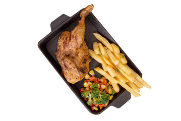 Half grilled chicken on hot plate with fries, bbq sauce and vegetables. Isolated photo perfect for advertising or commercial use